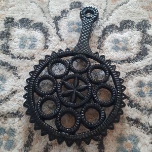 John Wright cast iron round trivet.